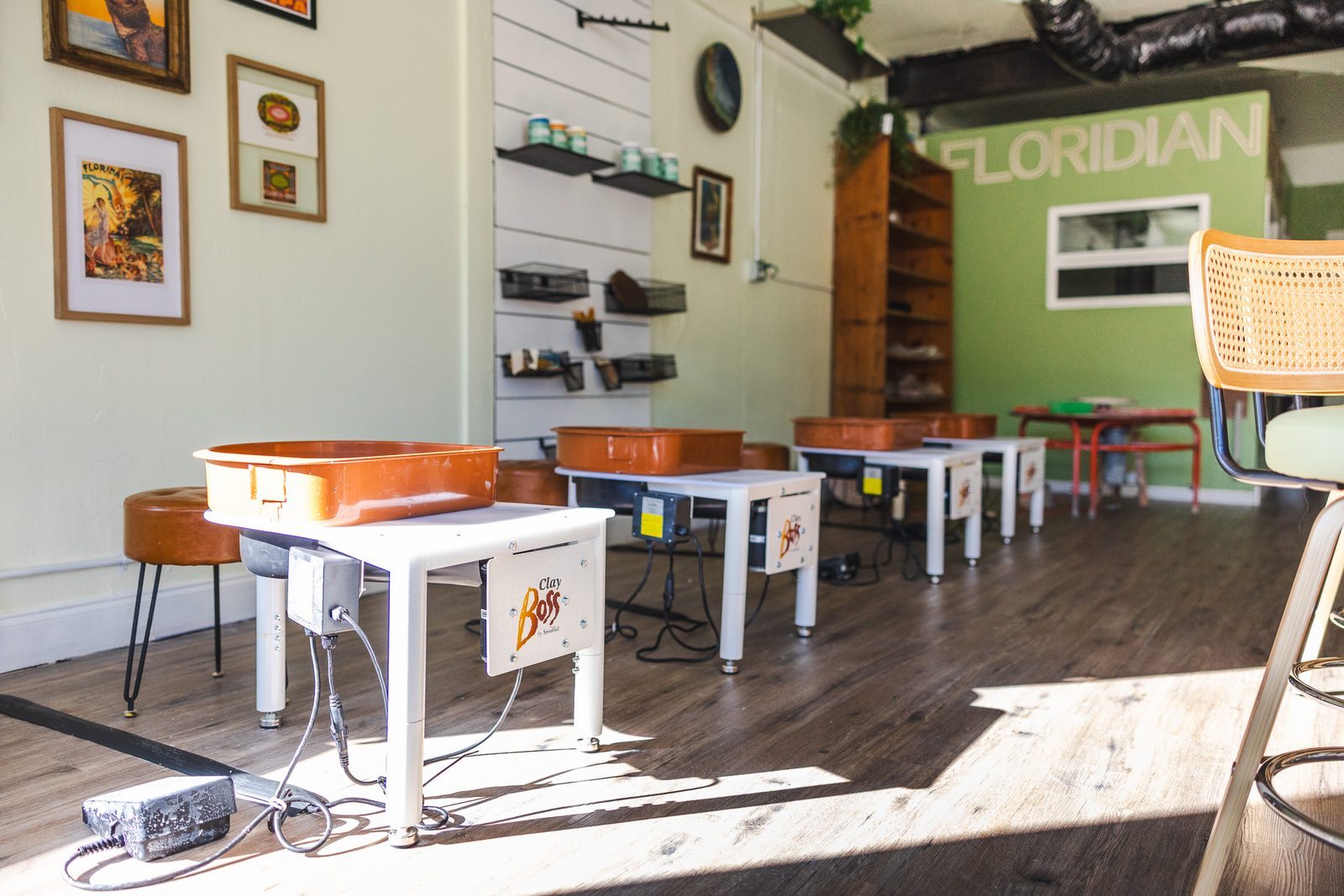 Floridian Ceramics studio in Tampa with pottery wheels and stools set up for a class