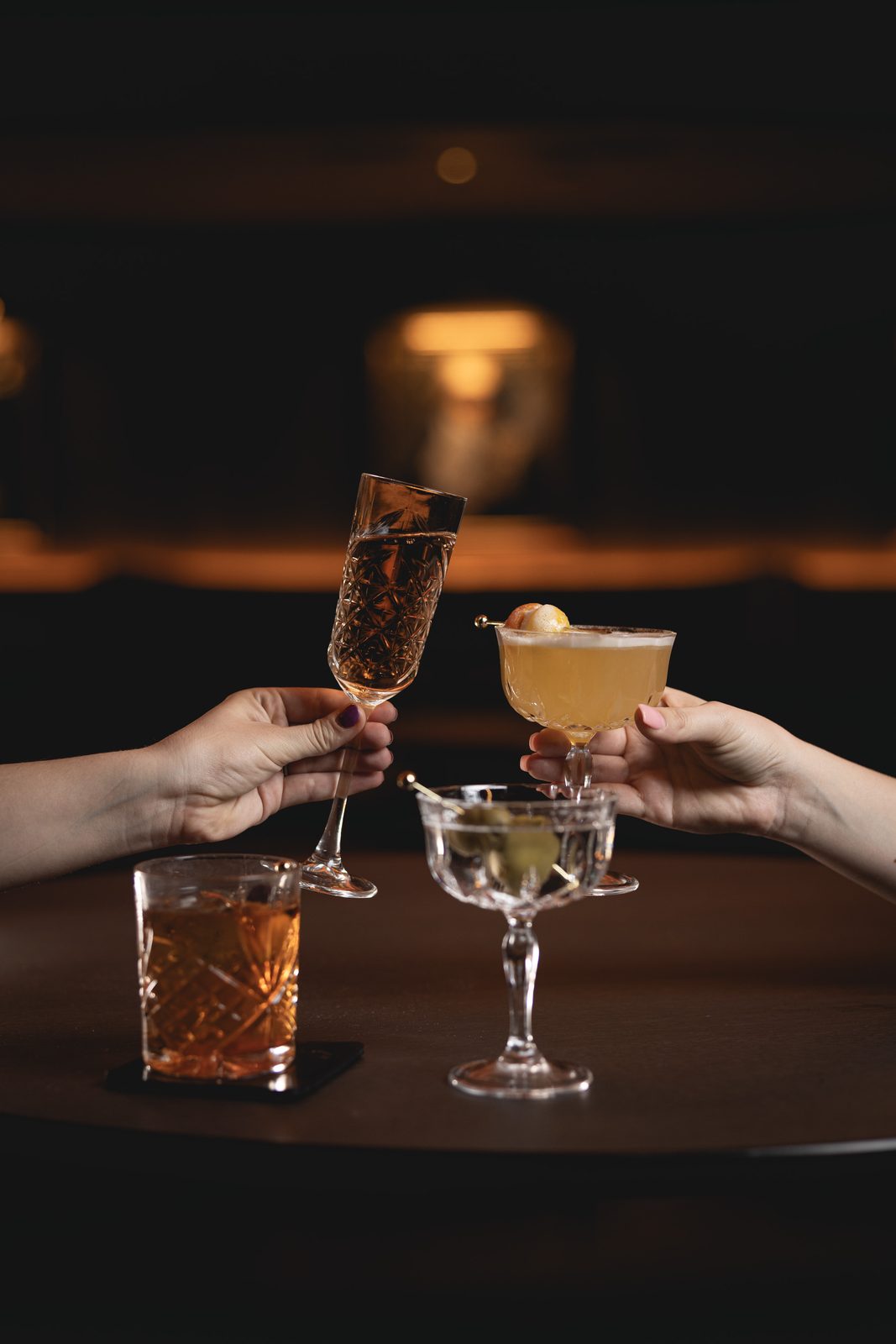 Two cocktails raised in a toast at the bar at Jekyll in Hyde Park, Tampa