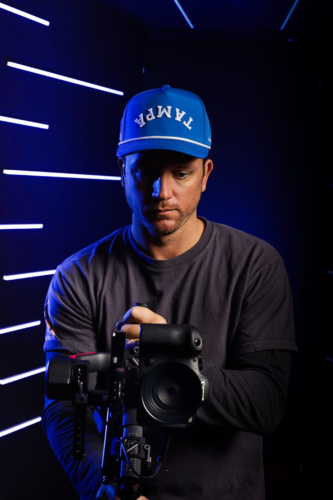 Cameron Melcher, photographer and filmmaker behind Rhône Studio, holding a cinema camera